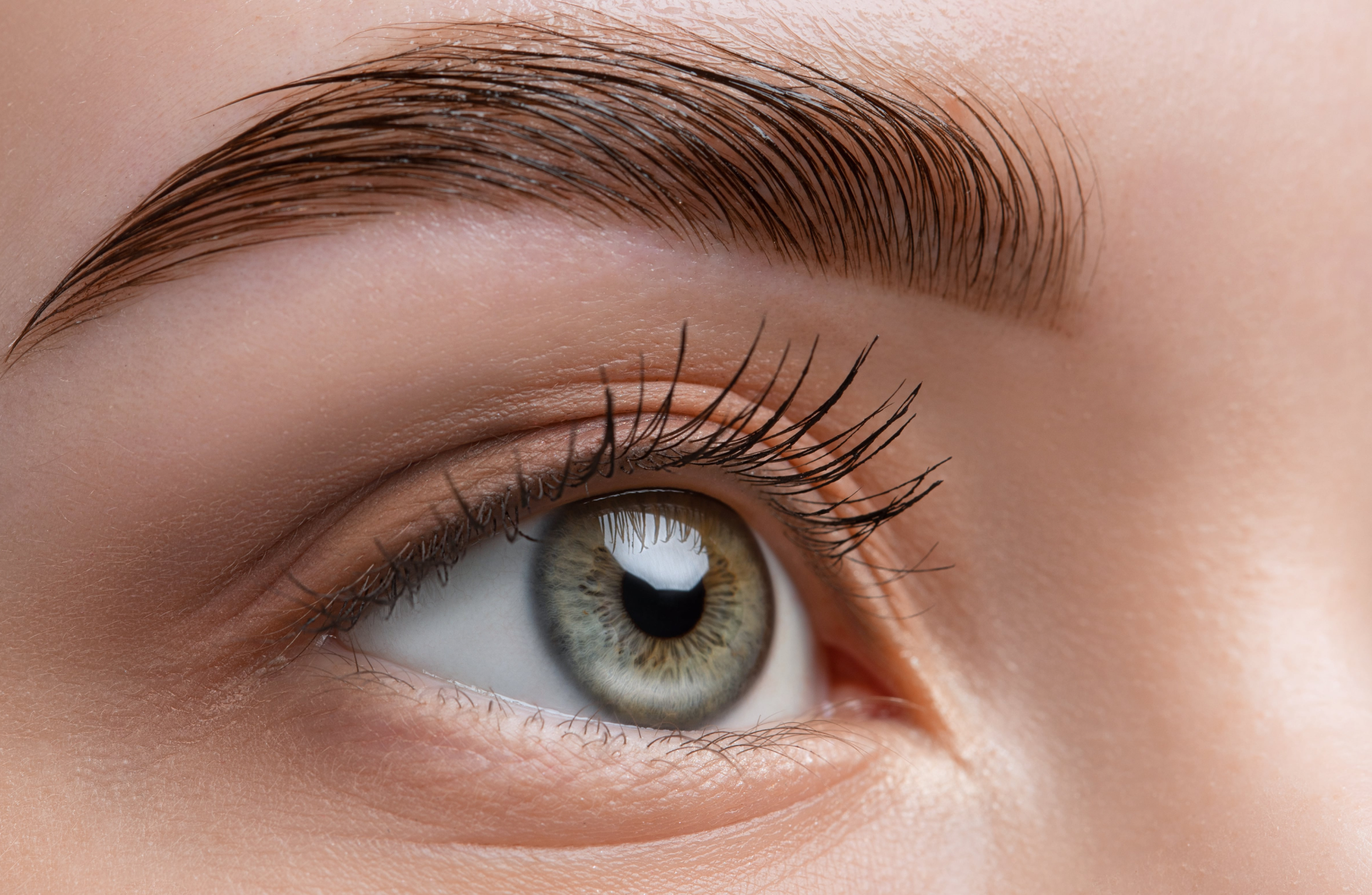 Woman with brow tint and lash lift looking to the right