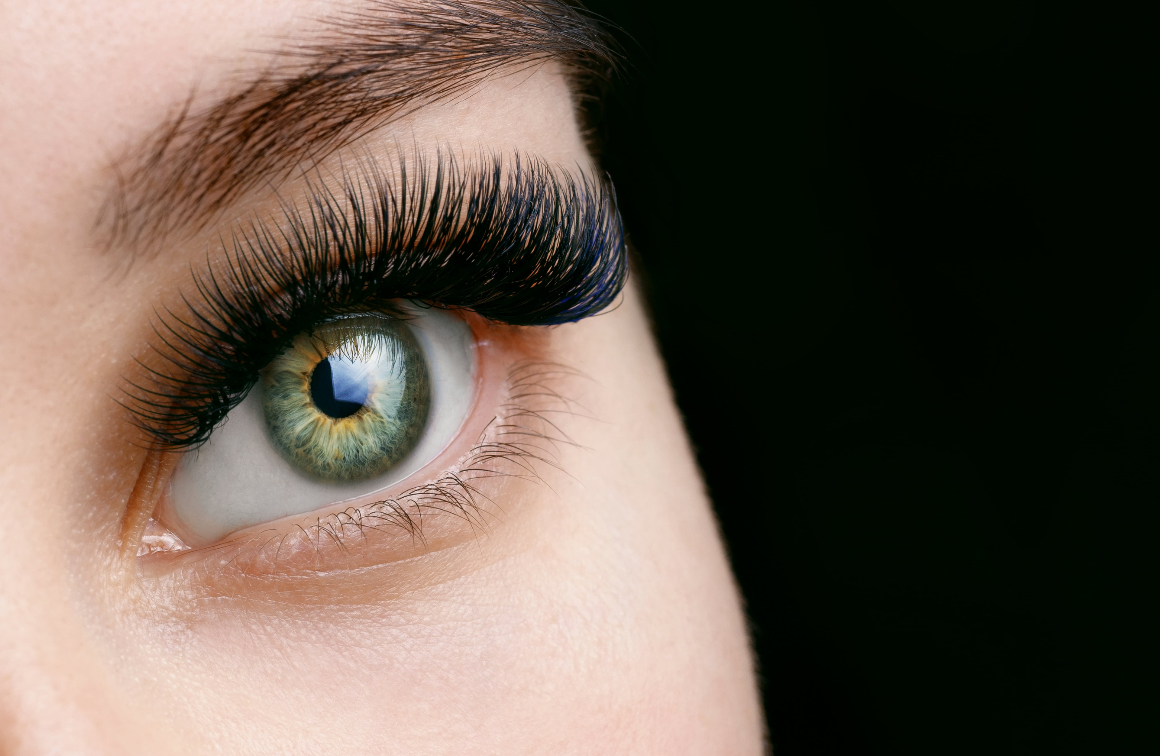 Close up of woman with eyelash extensions and green eyes