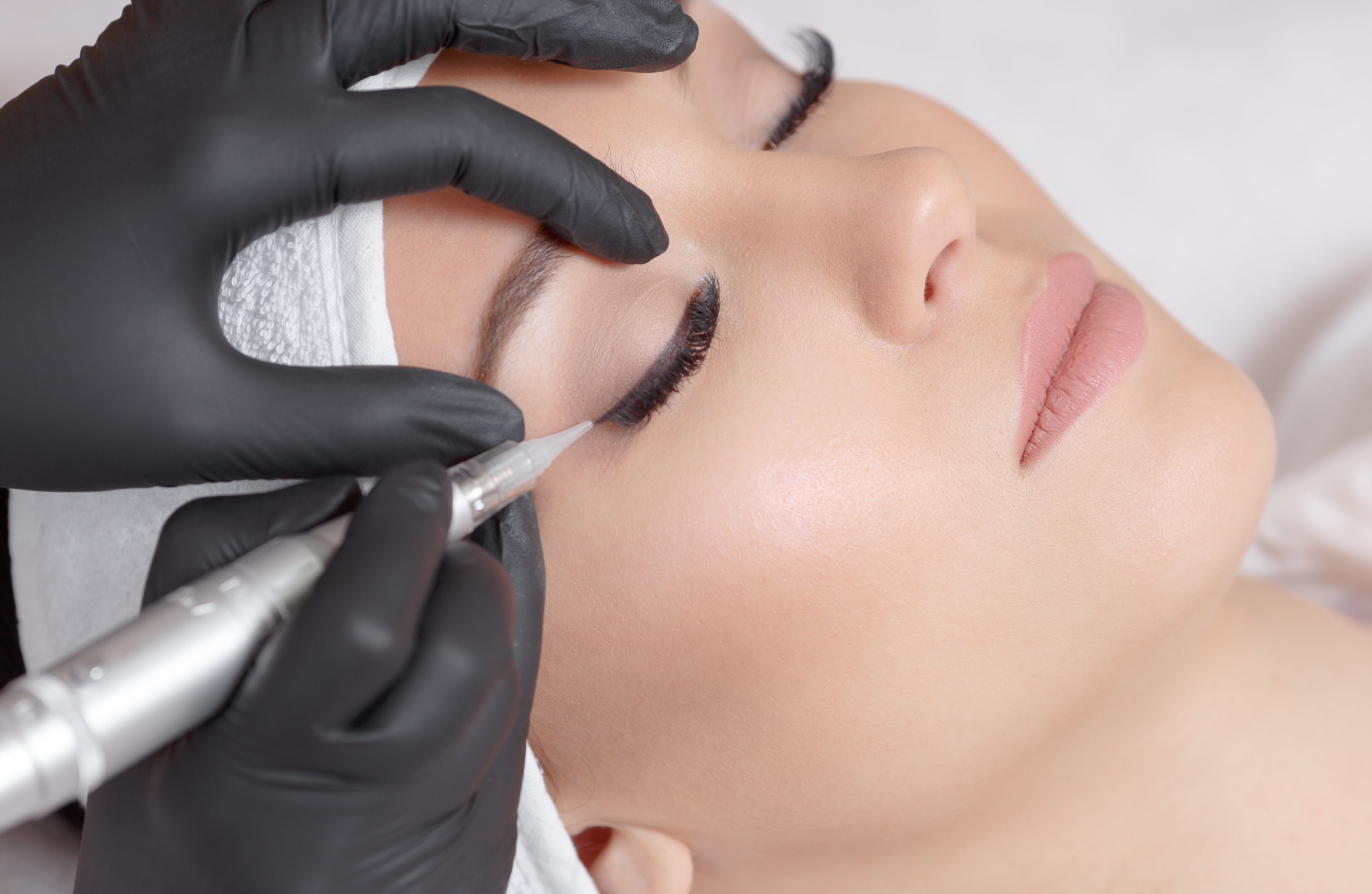 Woman receiving permanent makeup service